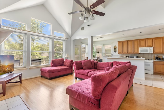 25603 Myrtle Spgs, Spring, TX 77373 - living area with healthy amount of natural light, a ceiling fan, light wood-type flooring, and high vaulted ceiling