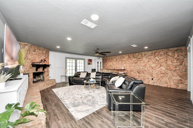 2514 Loganberry Cir, Seabrook, TX 77586 - living room with a ceiling fan, wood finished floors, a fireplace, recessed lighting, and a textured ceiling
