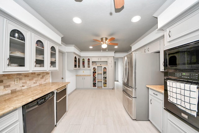 2514 Loganberry Cir, Seabrook, TX 77586 - kitchen featuring dishwashing machine, oven, a ceiling fan, freestanding refrigerator, and built in microwave