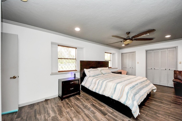 2514 Loganberry Cir, Seabrook, TX 77586 - bedroom with two closets, dark wood finished floors, recessed lighting, ornamental molding, and ceiling fan