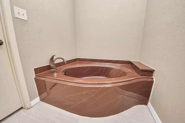 2514 Loganberry Cir, Seabrook, TX 77586 - bathroom with a bath and a textured wall