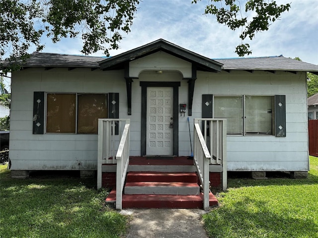 213 W Lobit St, Baytown, TX 77520 - view of front of house with a front lawn and a shingled roof