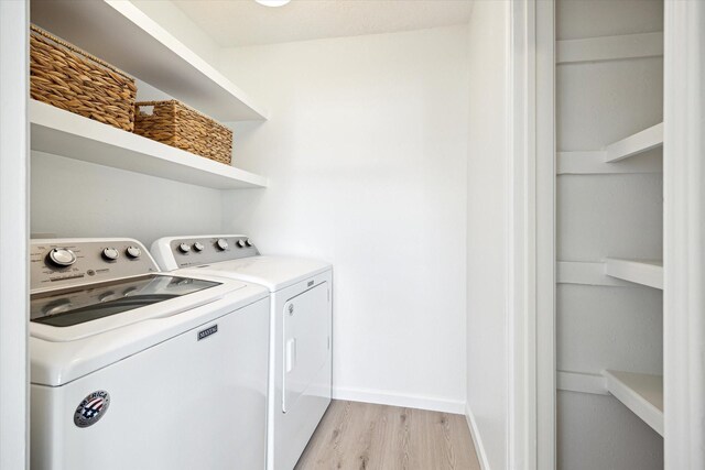 33 Lakewood Ln, Seabrook, TX 77586 - washroom with independent washer and dryer and light wood-style flooring