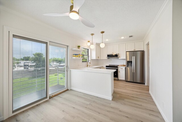 33 Lakewood Ln, Seabrook, TX 77586 - kitchen with appliances with stainless steel finishes, crown molding, a peninsula, light countertops, and white cabinetry