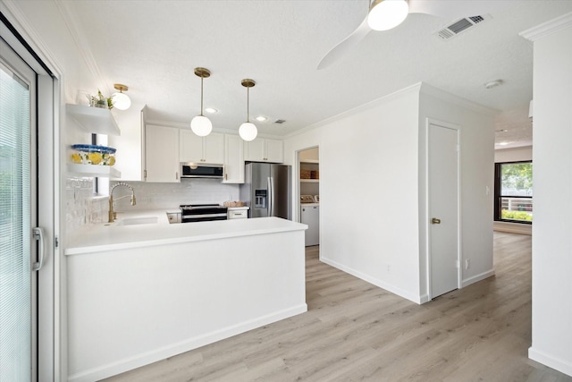 33 Lakewood Ln, Seabrook, TX 77586 - kitchen featuring appliances with stainless steel finishes, open shelves, ornamental molding, light countertops, and backsplash