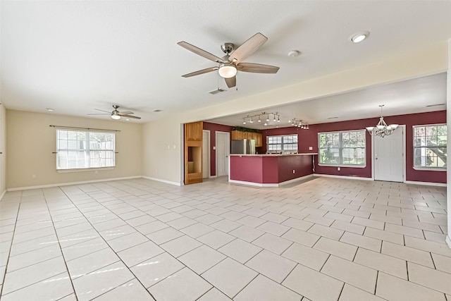 2206 Wimcrest St, Galveston, TX 77551 - unfurnished living room featuring a ceiling fan, track lighting, a chandelier, and light tile patterned flooring