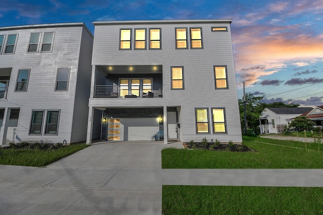 3602 Runnels St, Houston, TX 77003 - view of property with a balcony, concrete driveway, a lawn, and an attached garage