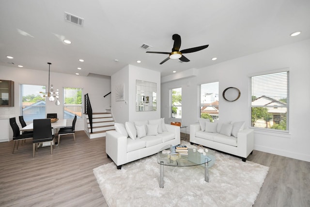 3602 Runnels St, Houston, TX 77003 - living room featuring stairs, light wood finished floors, recessed lighting, a chandelier, and ceiling fan