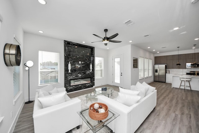 3602 Runnels St, Houston, TX 77003 - living room with light wood-type flooring, plenty of natural light, recessed lighting, a ceiling fan, and a high end fireplace