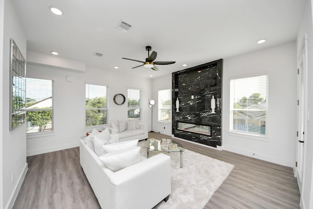 3602 Runnels St, Houston, TX 77003 - living area with plenty of natural light, ceiling fan, wood finished floors, a premium fireplace, and recessed lighting