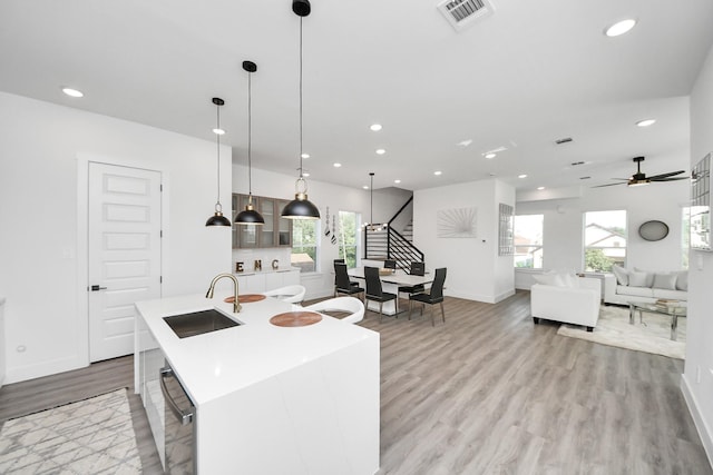 3602 Runnels St, Houston, TX 77003 - kitchen featuring light wood finished floors, recessed lighting, light countertops, a kitchen island with sink, and healthy amount of natural light