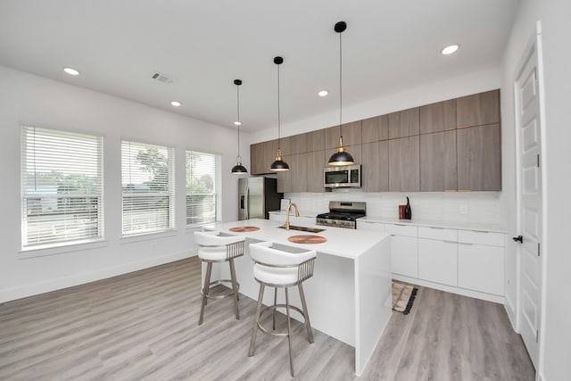 3602 Runnels St, Houston, TX 77003 - kitchen featuring stainless steel appliances, modern cabinets, a kitchen breakfast bar, backsplash, and recessed lighting