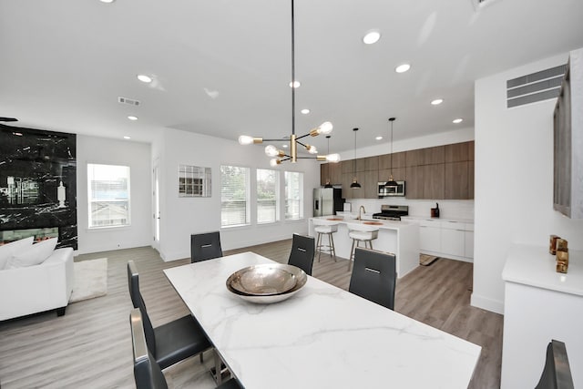 3602 Runnels St, Houston, TX 77003 - dining area featuring light wood-style flooring, recessed lighting, and a chandelier