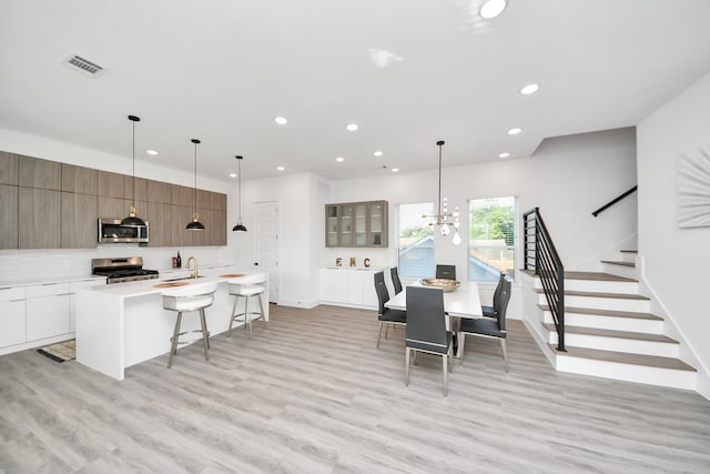 3602 Runnels St, Houston, TX 77003 - dining room with recessed lighting, light wood-type flooring, stairway, and a chandelier