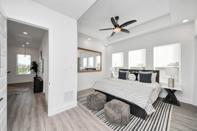 3602 Runnels St, Houston, TX 77003 - bedroom featuring attic access, wood finished floors, a tray ceiling, recessed lighting, and a ceiling fan