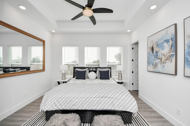 3602 Runnels St, Houston, TX 77003 - bedroom with multiple windows, recessed lighting, a tray ceiling, wood finished floors, and a ceiling fan