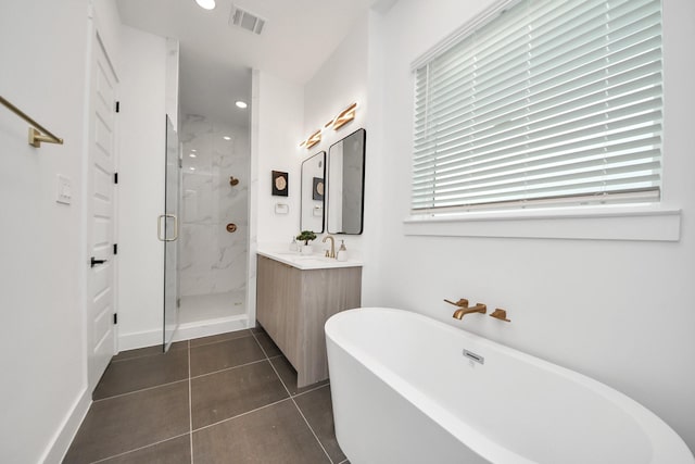 3602 Runnels St, Houston, TX 77003 - bathroom with a marble finish shower, vanity, a freestanding tub, tile patterned flooring, and recessed lighting
