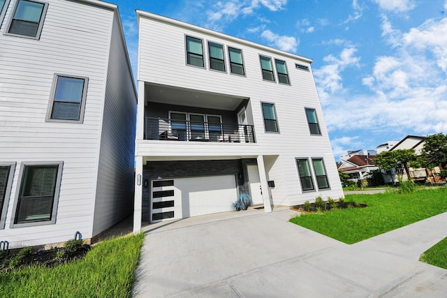3602 Runnels St, Houston, TX 77003 - view of property featuring a balcony, an attached garage, concrete driveway, and a front yard