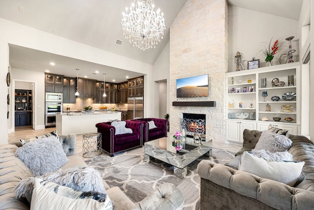 17023 Sweet Bay Ct, Conroe, TX 77385 - living room featuring a chandelier, a stone fireplace, high vaulted ceiling, and recessed lighting