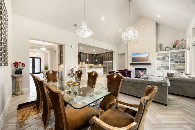 17023 Sweet Bay Ct, Conroe, TX 77385 - dining area with a chandelier, high vaulted ceiling, a fireplace, and recessed lighting