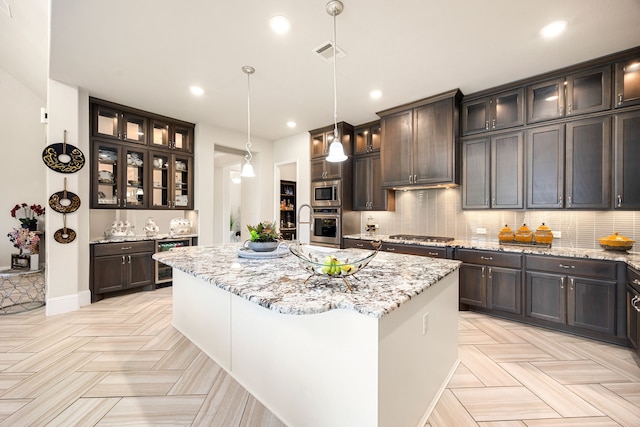 17023 Sweet Bay Ct, Conroe, TX 77385 - kitchen featuring stainless steel appliances, beverage cooler, a center island with sink, dark brown cabinets, and decorative backsplash