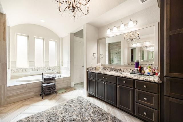 17023 Sweet Bay Ct, Conroe, TX 77385 - full bathroom featuring a chandelier, a garden tub, vanity, vaulted ceiling, and a tile shower