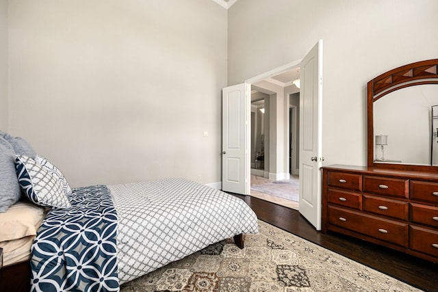 17023 Sweet Bay Ct, Conroe, TX 77385 - bedroom featuring dark wood-style flooring, ornamental molding, and a high ceiling