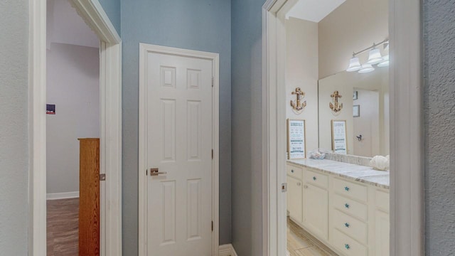 7475 Wooded Creek Dr, Beaumont, TX 77708 - bathroom featuring wood finished floors and vanity