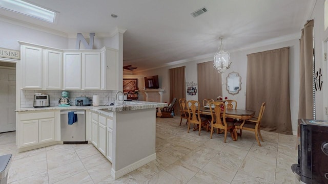 7475 Wooded Creek Dr, Beaumont, TX 77708 - kitchen with crown molding, dishwasher, a peninsula, backsplash, and white cabinets