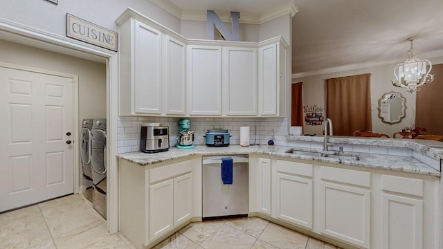 7475 Wooded Creek Dr, Beaumont, TX 77708 - kitchen with stainless steel dishwasher, washing machine and clothes dryer, crown molding, a chandelier, and decorative backsplash