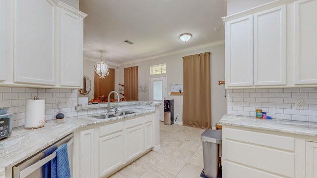7475 Wooded Creek Dr, Beaumont, TX 77708 - kitchen with ornamental molding, decorative backsplash, white cabinets, light stone counters, and a peninsula