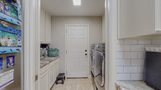 7475 Wooded Creek Dr, Beaumont, TX 77708 - laundry room with washer and clothes dryer and light tile patterned floors