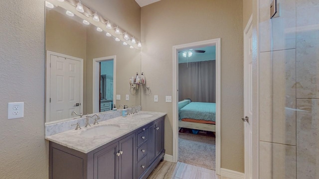 7475 Wooded Creek Dr, Beaumont, TX 77708 - ensuite bathroom featuring double vanity and baseboards