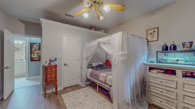 7475 Wooded Creek Dr, Beaumont, TX 77708 - bedroom with wood finished floors and a ceiling fan