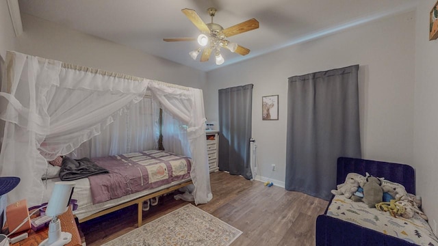 7475 Wooded Creek Dr, Beaumont, TX 77708 - bedroom with wood finished floors and a ceiling fan