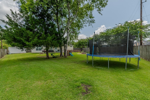 7475 Wooded Creek Dr, Beaumont, TX 77708 - fenced backyard with a trampoline and a playground