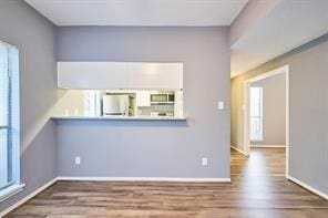 3724 Woodchase Dr, Houston, TX 77042 - unfurnished living room featuring wood finished floors and plenty of natural light