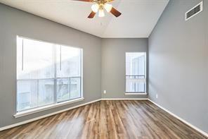 3724 Woodchase Dr, Houston, TX 77042 - spare room featuring a ceiling fan, wood finished floors, and lofted ceiling
