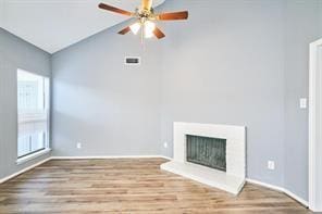 3724 Woodchase Dr, Houston, TX 77042 - unfurnished living room with healthy amount of natural light, wood finished floors, ceiling fan, a fireplace with raised hearth, and high vaulted ceiling