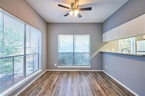 3724 Woodchase Dr, Houston, TX 77042 - empty room with wood finished floors and a ceiling fan