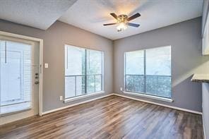 3724 Woodchase Dr, Houston, TX 77042 - unfurnished living room featuring wood finished floors and a ceiling fan