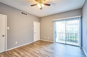 3724 Woodchase Dr, Houston, TX 77042 - spare room with wood finished floors and ceiling fan