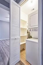 3724 Woodchase Dr, Houston, TX 77042 - laundry area with estacked washer and dryer and wood finished floors