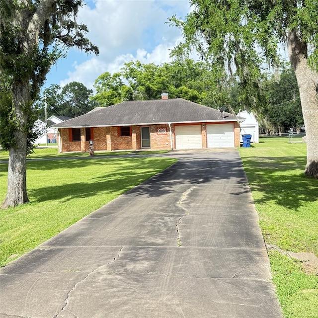 1410 S Dance Dr, West Columbia, TX 77486 - ranch-style house featuring a garage, asphalt driveway, a front lawn, and brick siding