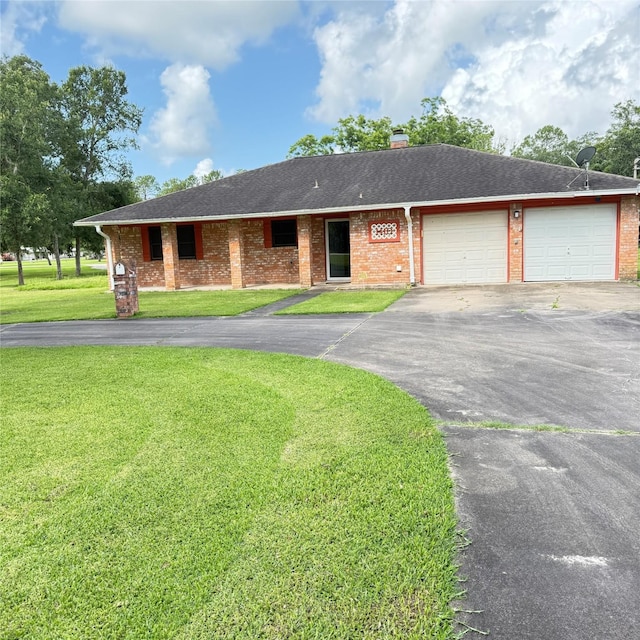 1410 S Dance Dr, West Columbia, TX 77486 - single story home with asphalt driveway, a front lawn, a garage, brick siding, and a chimney