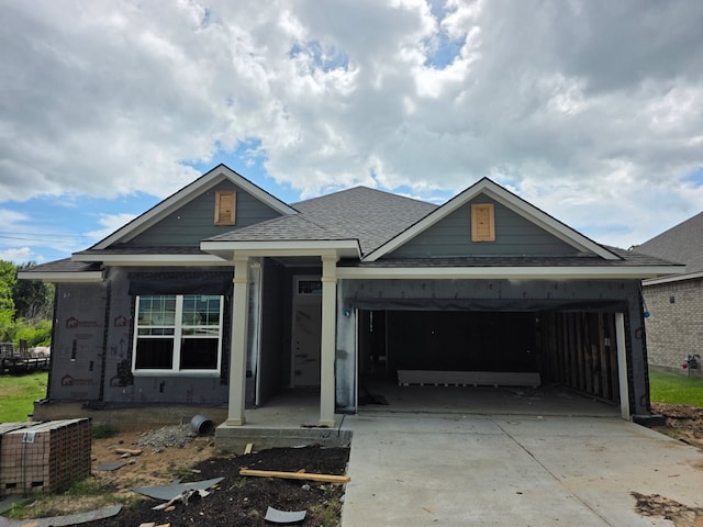 2058 Winepress Rd, Brenham, TX 77833 - view of front of home featuring an attached garage, concrete driveway, and roof with shingles