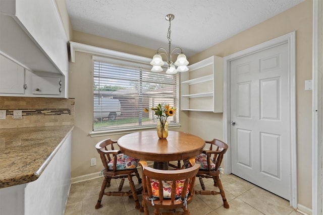 9602 Philmont Dr, Houston, TX 77080 - dining space with a chandelier, light tile patterned flooring, and a textured ceiling