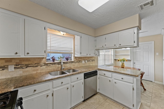 9602 Philmont Dr, Houston, TX 77080 - kitchen with stainless steel dishwasher, black range oven, plenty of natural light, decorative backsplash, and a textured ceiling