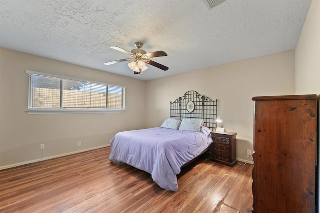 9602 Philmont Dr, Houston, TX 77080 - bedroom with wood finished floors, a textured ceiling, and ceiling fan