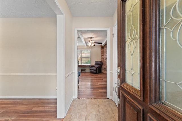 9602 Philmont Dr, Houston, TX 77080 - entryway featuring a textured ceiling, a ceiling fan, and light wood-style flooring